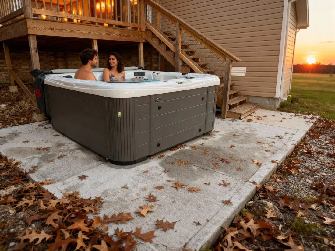 Cozy luxury cabin with private hot tub overlooking Table Rock Lake in autumn, with fall foliage, a couple enjoying wine on wooden deck at sunset, Ozark Mountains backdrop, warm interior lights glowing, professional travel photography style